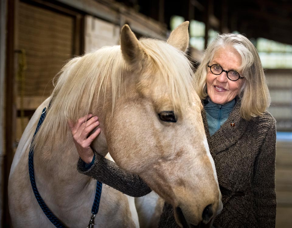 A close up of Suzy and her beloved horse named Secret.