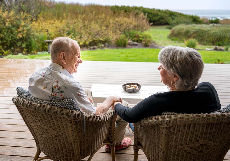 Tom and his wife sharing a quiet moment together on their deck over looking the ocean.