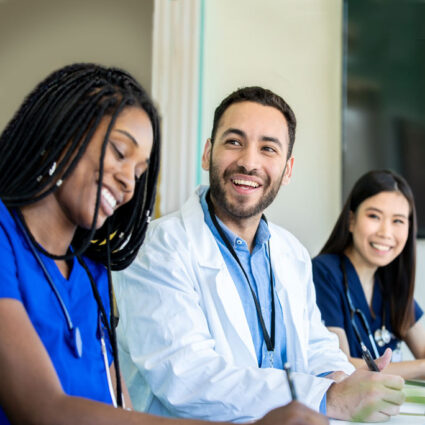 Smiling residents at a meeting.
