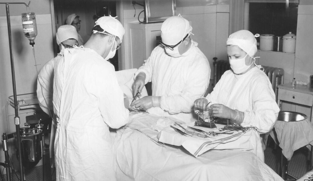 Clinicians performing surgery, date unknown.