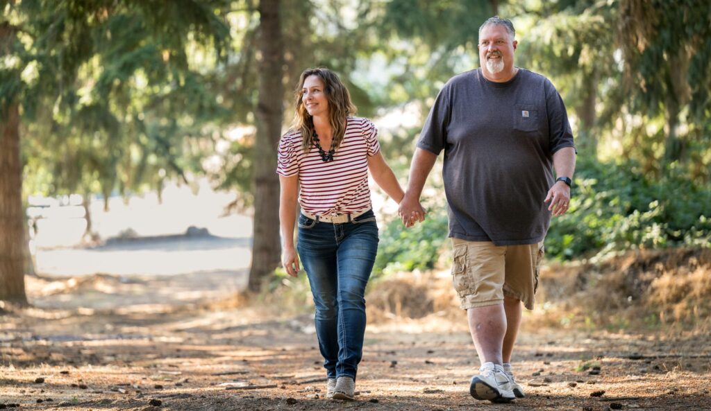 Scott and Angie walking hand in hand.