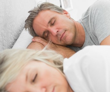 Couple sleeping in bed.
