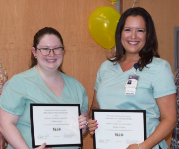 Colleen Getty and Kelsey Lovejoy with their employee of the year awards.