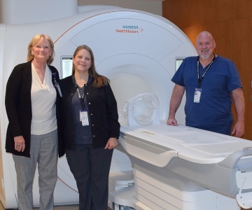 Employees at Samaritan North Lincoln Hospital. standing in front of a new MRI machine.