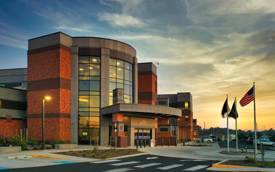 Front entry of Samaritan Pacific Communities Hospital at sunset with clouds. Newport, Oregon.