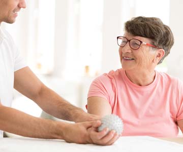 person holding ball during stroke rehabilation