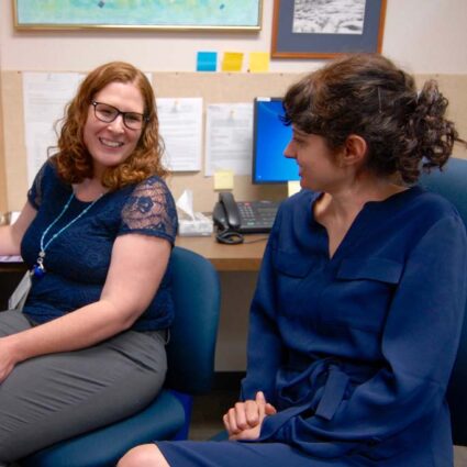 Two medical residents chatting in an office.