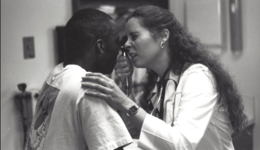 Albany General Hospital clinician giving an eye exam, date unknown.