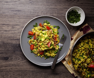 Vibrant vegetables in a creamy yellow tofu scramble.