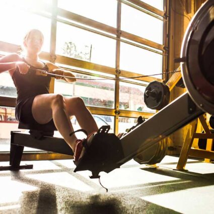 woman working out on rowing machine