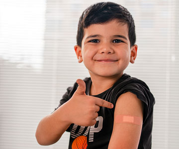Boy smiles after receiving a shot